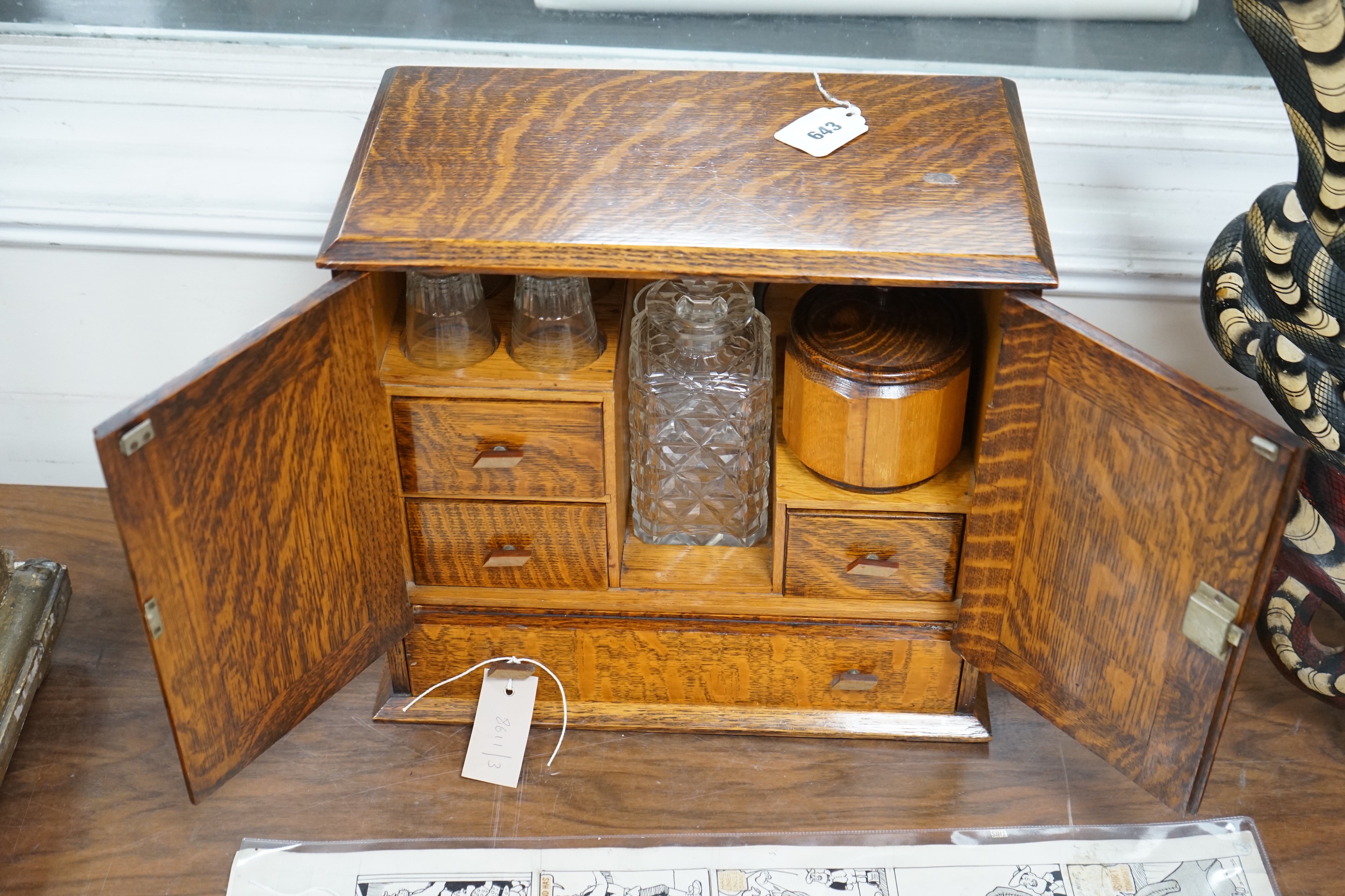 A 1920's oak smoker's / drinks box with decorative interior. 36cm tall, 39cm wide